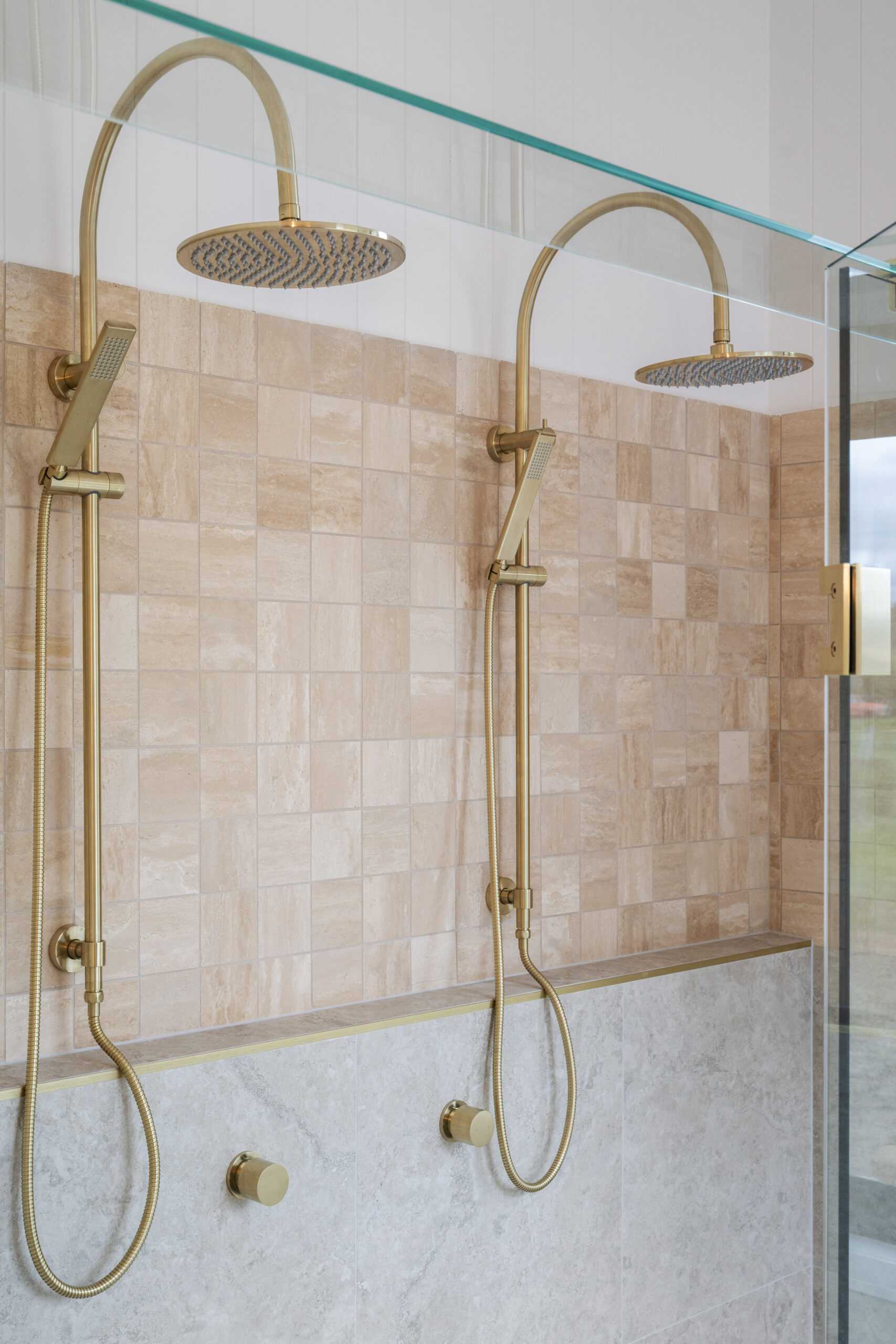 This double shower is true luxury - square stone tiles, brushed brass tapware, a beautiful blend of mixing straight and angular lines with soft, round curves.
